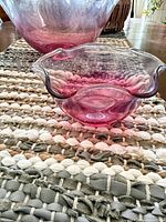 Close-up of small ruffled glass bowl in front of larger bowl