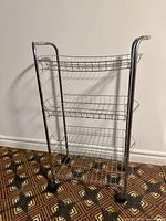 Front view of chrome 4-tier wire cart on casters