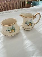 creamer and sugar bowl side by side showing pattern and form