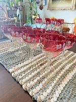 Close-up of coupes showing ruby overlay, floral enamel and gold rim