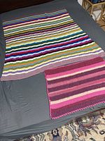 Both crochet blankets displayed flat showing size difference and patterns