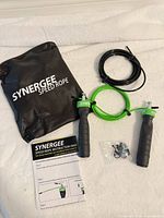 Entire kit laid out: handles, green and black cables, spare hardware, instruction manual, carry bag
