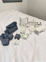 Group shot of all dollhouse furniture pieces on white surface