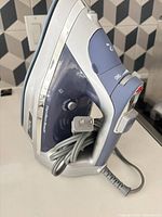 Full view of Hamilton Beach steam iron showing brand and cord