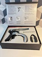 Open box showing wine opener, spare worm, foil cutter in foam insert