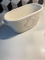 Full view of oval ceramic bowl showing shape and handle