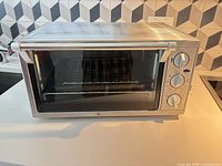 Front view of stainless steel toaster oven on countertop