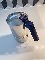 Assembled moka pot showing overall form and blue handle