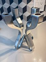 Full view of four-arm polished chrome aluminum candelabra