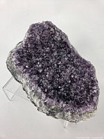 Full view of amethyst cluster on acrylic stand