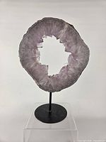 Front view of amethyst ring slice on stand