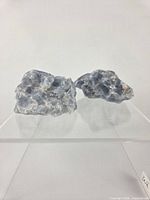 Two blue calcite chunks on display stand