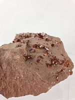 Close view of vanadinite crystals on matrix highlighting crystal habit