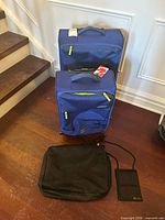 Two blue American Tourister suitcases with packing cube and document holder