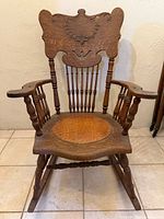 Front view showing overall form, turned spindles, leather seat