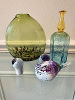 Group shot of four art glass items