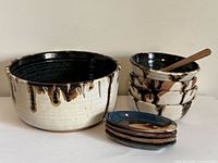 Group view of all pottery pieces and spoon