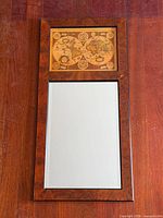 Full view of rectangular wood-framed wall mirror showing map panel above mirror