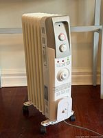 Full view of Garrison radiator heater showing fins, wheels and cord