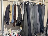 Rack with casual pants, dress pants and shorts in assorted colours