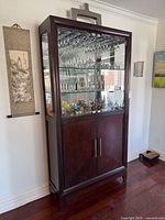 Full view angled shot of cabinet showing glass display top and wood lower section