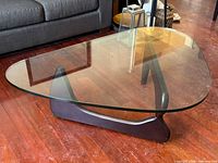 Full view of triangular glass coffee table