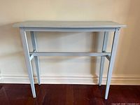 Front view of pale blue painted wooden console table