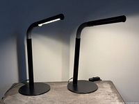 Both desk lamps side by side illuminated