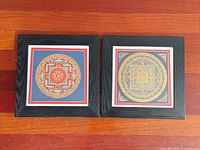 Both framed mandala prints side by side in black frames