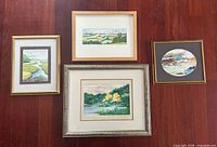 Group shot of four framed watercolour landscapes signed Mickie