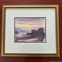 Front view of framed signed watercolour depicting Eilean Donan Castle at sunset