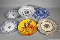 Six assorted plates laid out showing fronts