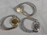 Three watches laid out to show overall appearance and band styles