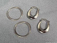 Both pairs of gold hoop earrings side by side
