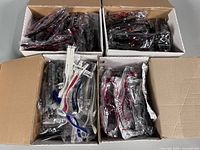 Four cardboard boxes filled with Ben.X eyeglass frames sealed in plastic sleeves