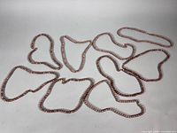 All nine agate bead necklaces laid out to show quantity and uniform style