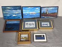 All eight framed artworks arranged to show variety and relative sizes
