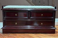 Front view showing wood finish, faux drawers, brass pulls