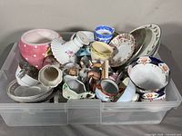 overview of bin filled with assorted chinaware pieces