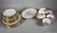 Full set laid out: stacks of plates, oval platter, cups and saucers