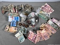 Overall spread of assorted world banknotes and coins