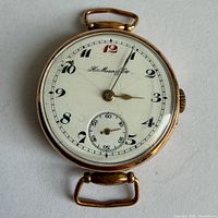 Front view of watch showing enamel dial, numerals and crack at 10