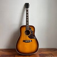 Full front view of sunburst Emperador Hummingbird acoustic guitar