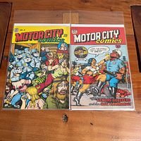 Front covers of both Motor City Comics issues in sleeves