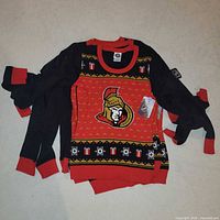 Stack of identical Ottawa Senators women’s sweaters showing front design and tags