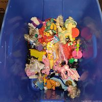 Top view of blue tote filled with mixed vintage toys