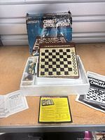 Overall lot: board seated in styrofoam with pieces, box behind