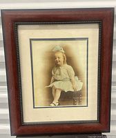 Full view of framed hand-tinted photograph with wood frame and mat