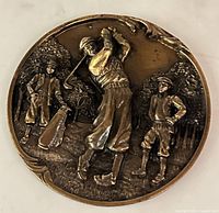 obverse of medal showing raised golfer scene