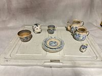 group shot of all ten blue & white ceramic pieces